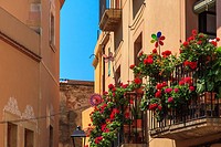 Bright flowers and plants on balconies in the old town of Tarragona, Catalonia, Spain.