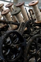 Spools of wool on industrial revolution textile machinery, Bradford, England, UK.