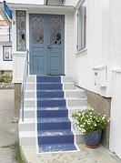 Blue painted stair carpet on traditional wooden house in coastal conservation area near Gothenburg, Sweden.