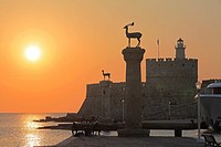 Greece, Dodecanese, Rhodes, Mandraki Harbour, Tower of St Nicholas, sunrise,.