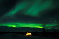 Nightsky and trappers tent lit up with aurora borealis, northern lights, wapusk national park, Manitoba, Canada.