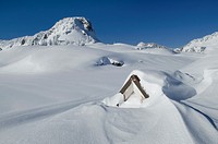 Stone structure nearly buried by winter snows, North Cascades washington.
