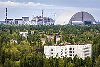 Aerial view of Pripyat ghost city, Ukraine. View with New Safe Confinement of Chernobyl Nuclear Power Plant.