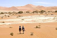 A young couple walking on the desert.