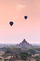 Hot air balloons floating over Bagan temples at sunrise, Bagan, Myanmar.