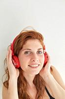 Portrait of young redhead woman with headphones