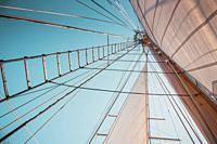 Looking up view of rigging and sails on an antique sailing ship