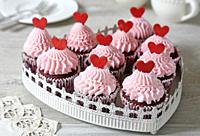 Red velvet cupcakes decorated with red hearts.
