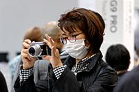 March 3, 2018, Yokohama, Japan - A woman tries out the new Lumix camera DC-GX7 MK3 at the CP+ Camera & Photo Imaging Show 2018 in Pacifico Yokohama. J...