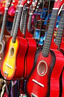 Red guitarrs for sale at a festival.