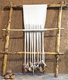 Reconstructed prehistoric age weaving loom. Mudwall ancient house replica.