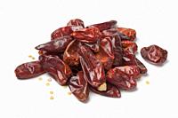 Heap of dried red hot chili peppers on white background.