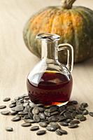 Bottle with tasty pumpkin seed oil and roasted seeds.