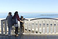 Family contemplating the views from the promenade by the sea in Altea, province of Alicante, Spain.