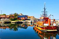 Orange pilot boat in Vasterhamn (west harbour) on the island of Oja (Landsort), the southernmost point in the Stockholm archipelago, Sweden, Scandinav...