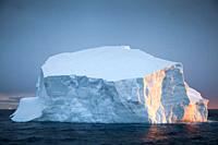 Antarctica. Iceberg near the Antarctic continent, sunset reflection on ice