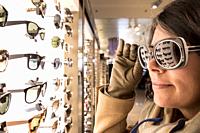 Woman Testing Sunglasses in Retail Store.