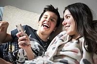 Kids watching funny videos together on smart phone.
