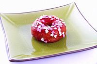 Colorful donut on a plate.