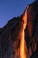 February setting sun reflects off Yosemite's seasonal Horsetail Fall, giving a molten lava appearance.