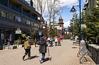 People walking in the street in Whistler village, British Columbia, Canada.