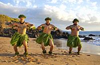 Three hula dancers at sunset at Wailea, Maui, Hawaii.