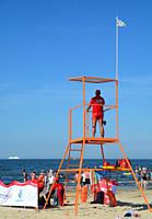 Life guard in his tower on the beach in Swinoujscie, Poland, Europe.