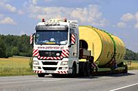 Wide load transport of a silo by MAN TGX 26. 540 semi trailer of Peter-Star, Poland on the road in South of Finland. Salo, Finland - July 27, 2018.