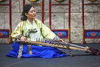 Musician plays gayageum, traditional instrument, at Korean Festival, Getty Center, Los Angeles CA.
