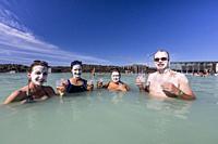 Guests enjoy the thermal waters and mud treatments of the Blue Lagoon, BlaÌ. a loÌ. nið , Iceland.