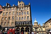 Crowd of tourists and historic highrise stone buidings on the Royal Mile in the Old Town of Edinburgh Scotland UK.