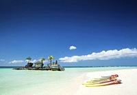tropical beach christian shrine and tourist canoes on boracay island philippines.