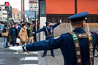 23. 12. 2017, Kyoto, Japan, Asia - Traffic wardens are seen regulating the flow of traffic at an intersection in Kyoto's old city.