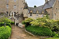 Front of Cawdor Castle with drawbridge bell and Stags Head Buckel Be Mindfull emblem in the rain Cawdor Nairn Scotland UK.