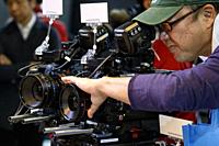 November 15, 2018, Tokyo, Japan - A visitor tries out a Canon cinema camera during the International Broadcast Equipment Exhibition (Inter BEE) 2018 a...