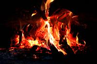 Fire wood brighly burning in furnace. Firewood burn in rural oven. Burning firewood in fireplace closeup. Fire and flames. Close up of burning fire wo...