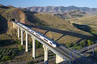 view of a high-speed train crossing a viaduct in Purroy, Zaragoza, Aragon, Spain. AVE Madrid Barcelona.
