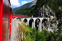 One way to the WEF: The Glacier Express Unesco World Heritage train trip through the swiss alps at the famous Landwasser-Viadukt.