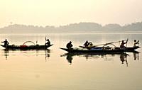 Guwahati, Assam, India. January 30, 2019. Fishermen lays their fishing net at the Brahmaputra River during sunset.