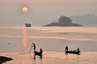 Guwahati, Assam, India. January 30, 2019. Fishermen lays their fishing net at the Brahmaputra River during sunset.