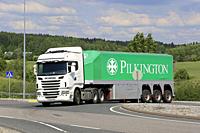 White Scania R560 truck and Pilkinton glass transport trailer on road intersection on a day of summer in Salo, Finland - June 2, 2018.