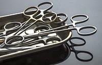 Some scissors for surgery on a tray, conceptual image, horizontal composition.