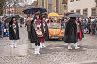 STUTTGART, GERMANY - MARCH 5:group of majorettes under umbrellas against rain. Shot under rain at Carnival parade in city center on march 5, 2019 Stut...