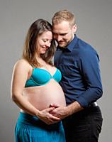 Pregnant Woman and her Man touching the Belly.