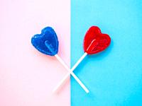 Red and blue lollipops on a pink and blue background.