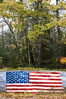 USA, Maine, Five Islands, US flag painted on rock.