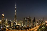 The Burj Khalifa and city skyline at night in downtown Dubai, UAE, Middle East.