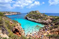 CALO DES MORO, MALLORCA, SPAIN - JULY 27, 2019: Small extremely turquoise bay and steep cliffs on a sunny day on July 27, 2019 in Calo des Moro, Mallo...