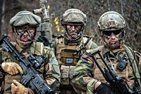 Norwegian Rapid reaction special forces FSK soldiers in field uniforms posing in the forest.