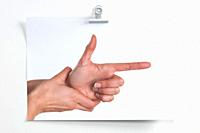 Blank sheet hanging on the wall with image of hands simulating a gun that shoots.